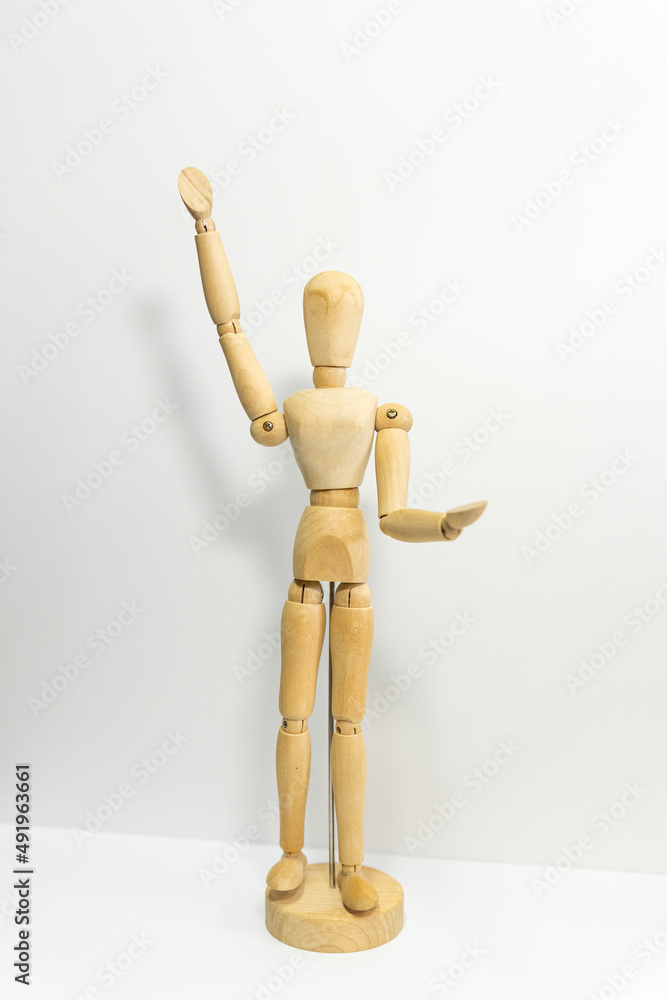 wooden mannequin rasing up its' hand wooden mannequin rasing up its' hand