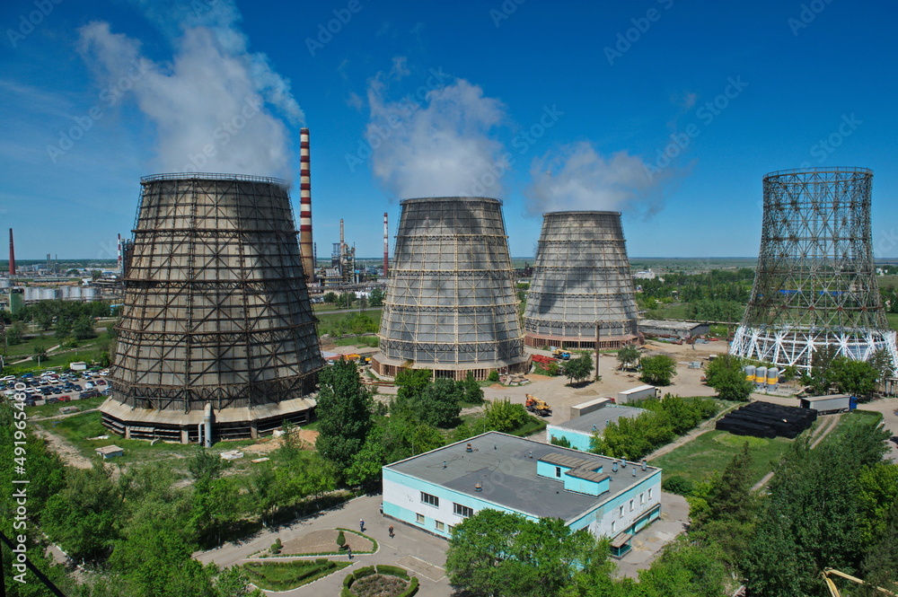Pavlodar, Kazakhstan - 05.29.2015 : Cooling towers and pipes of various compartments of a large thermal power plant