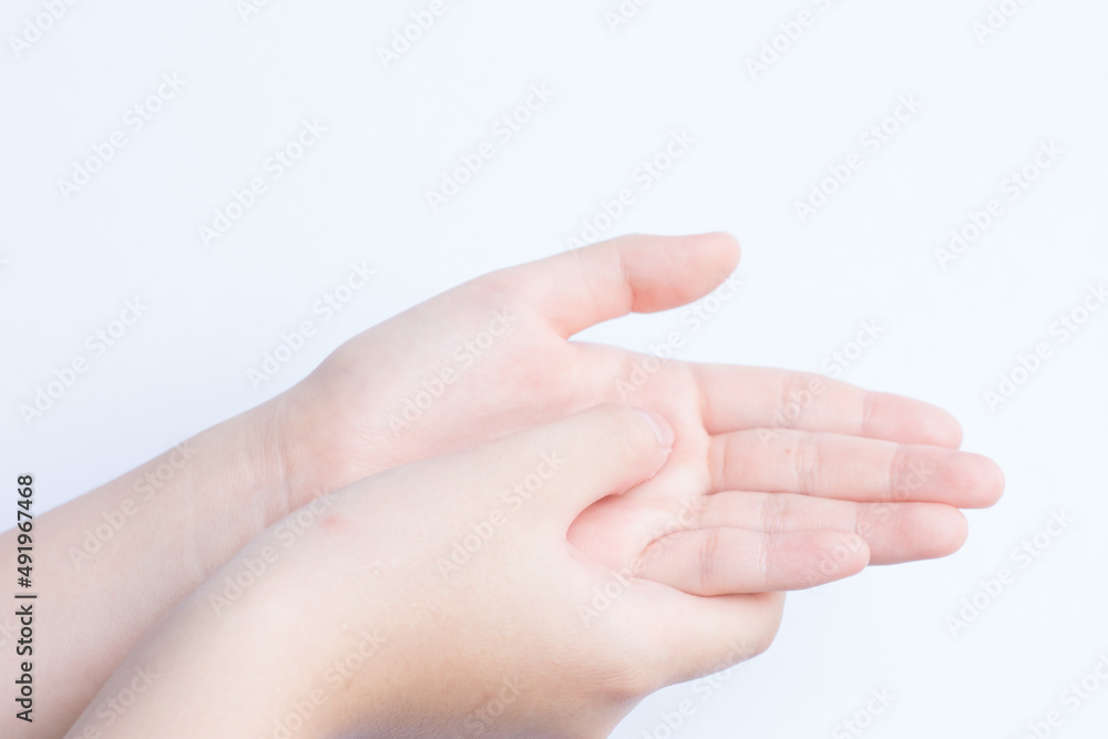 Young women using hand sanitizer to clean the bacteria on her hands. Isolated in white background. Young women using hand sanitizer to clean the bacteria on her hands. Isolated in white background.