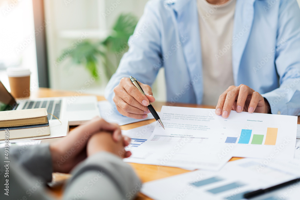 Business negotiation concept the male chattel dealer showing his information to the female realtor Business negotiation concept the male chattel dealer showing his information to the female realtor