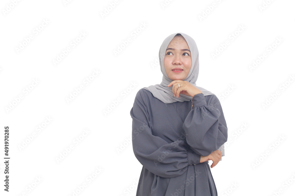 Smiling asian muslim woman while thinking something good. Isolated on white background Smiling asian muslim woman while thinking something good. Isolated on white background