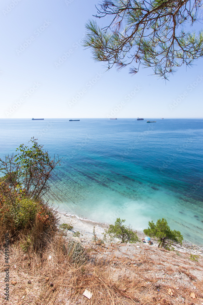 Beautiful summer landscape. View of the forest, rocks and sea coast. Hiking in scenic areas, the road to the wild beach. The resort town of Gelendzhik. Russia, Black sea coast Beautiful summer landscape. View of the forest, rocks and sea coast. Hiking in scenic areas, the road to the wild beach. The resort town of Gelendzhik. Russia, Black sea coast
