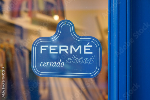 vintage shop sign ferme in french and cerrado in spanish text means english shop closed