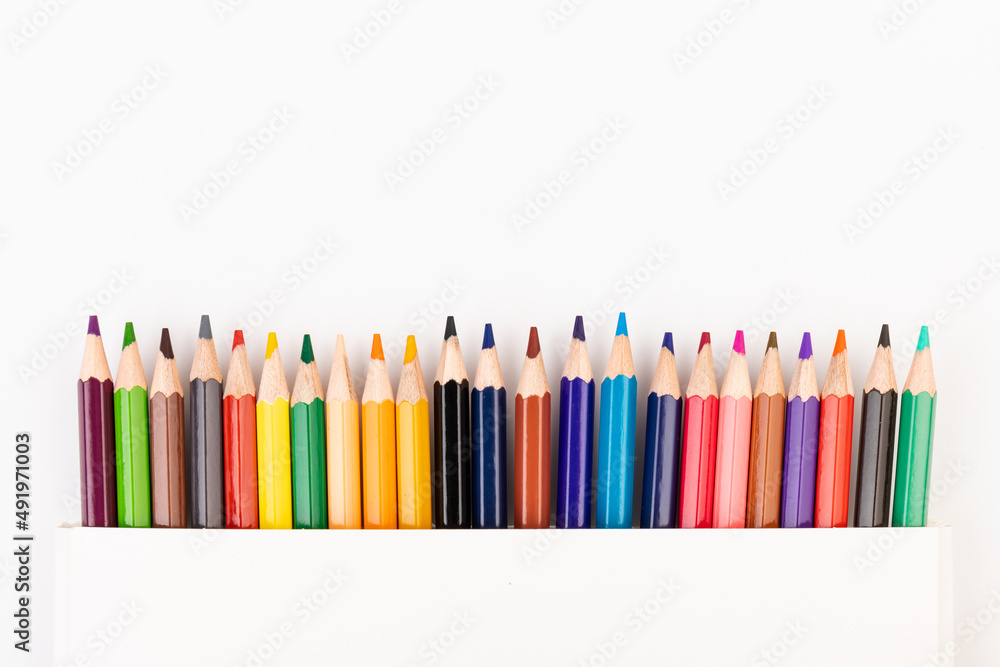 Many multicolored pencils, isolated on white background with copy space. Art and education background. Many multicolored pencils, isolated on white background with copy space. Art and education background.
