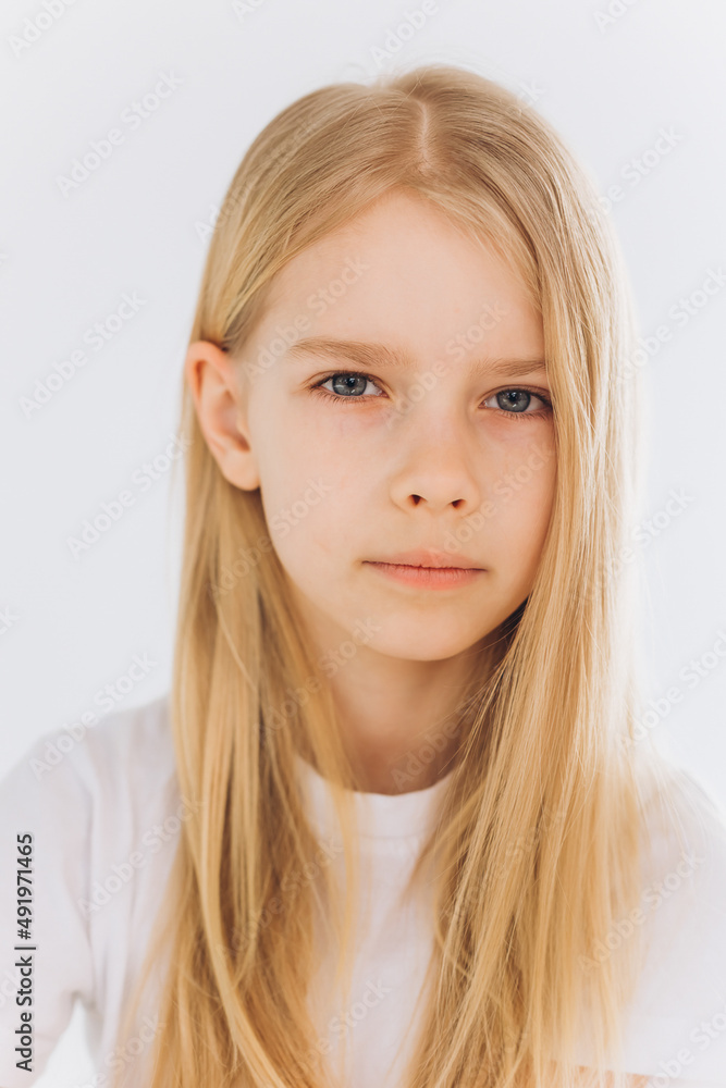 Young blondie girl portrait. Natural blondie hair, happy smiling caucasian girl on white background Young blondie girl portrait. Natural blondie hair, happy smiling caucasian girl on white background