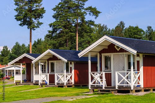 Leinwand Poster Red Holiday cottages on a camping ground