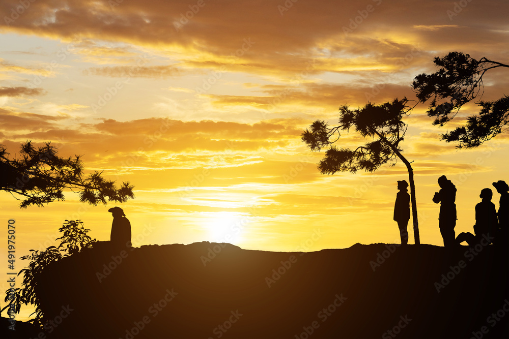 silhouette people on mountain with sunset background silhouette people on mountain with sunset background