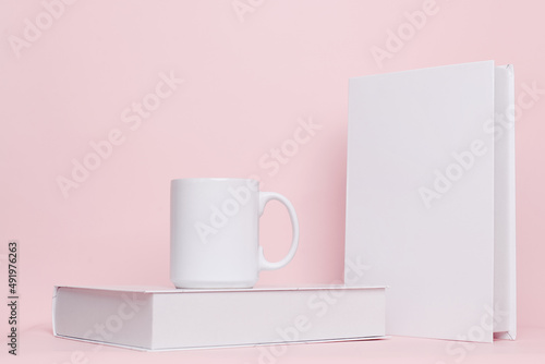 Mug and book combination for mock up isolated on pink background