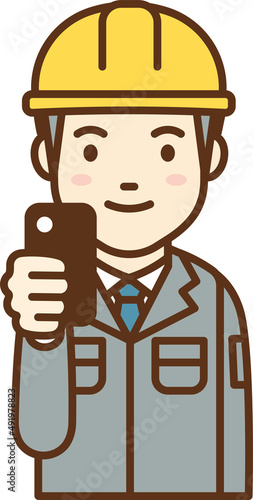 Man in work clothes holding a cell phone