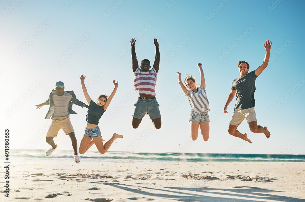 Break loose with your best friends. Shot of a group of young friends jumping enthusiastically in the air at the beach. Break loose with your best friends. Shot of a group of young friends jumping enthusiastically in the air at the beach.