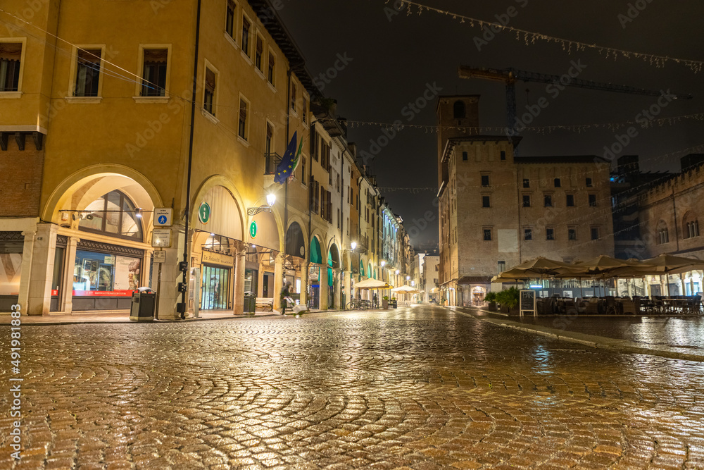 The center of Mantua in the square of herbs between the arcades and the shops at night