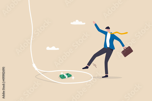 Fotografie, Obraz Money trap to trick greed people, danger fraud or threat to attack victim, financial or investment problem concept, greed businessman try to step into tricky rope trap to get money banknotes bundle