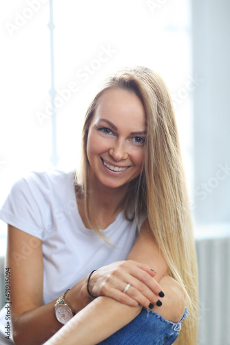 Happy blonde woman smiling at home