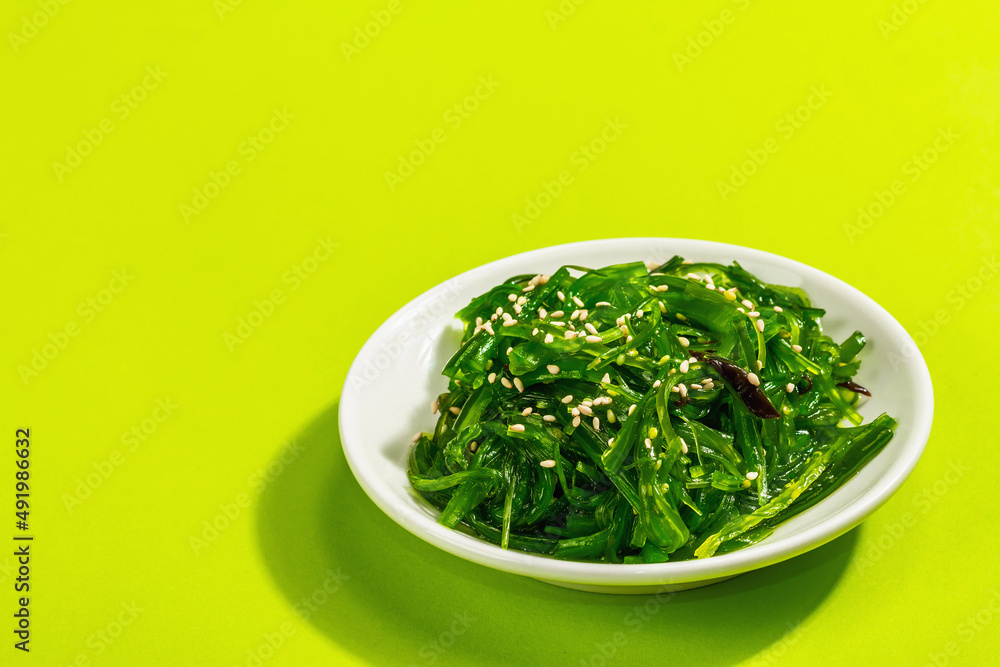 Chuka Seaweed Salad with sesame seeds and nut sauce. Trendy hard light, dark shadow Chuka Seaweed Salad with sesame seeds and nut sauce. Trendy hard light, dark shadow
