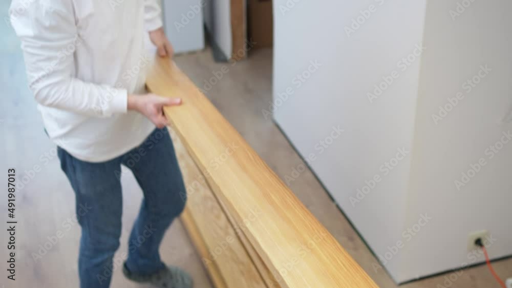 carpenter lifts and carries wood. manufacture of furniture from natural wood carpenter lifts and carries wood. manufacture of furniture from natural wood