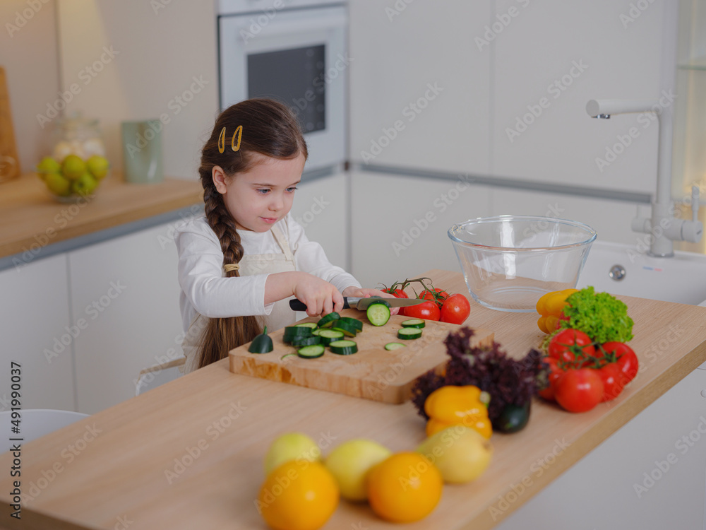 Young Girl Vlogger Making Social Media Video About Cooking At Home, looking on smartphone on tripod. episode about healthy eating. concept of attraction children to healthy diet of early age Young Girl Vlogger Making Social Media Video About Cooking At Home, looking on smartphone on tripod. episode about healthy eating. concept of attraction children to healthy diet of early age