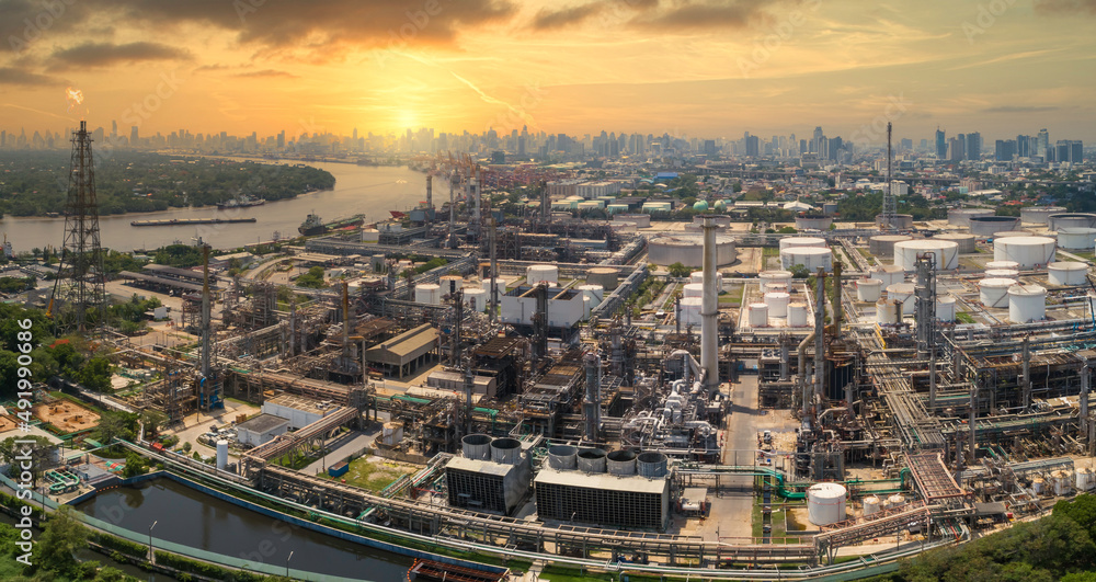 Aerial view panorama image of oil and gas industry  refinery and petrochemical plant against urban scene in sunrise