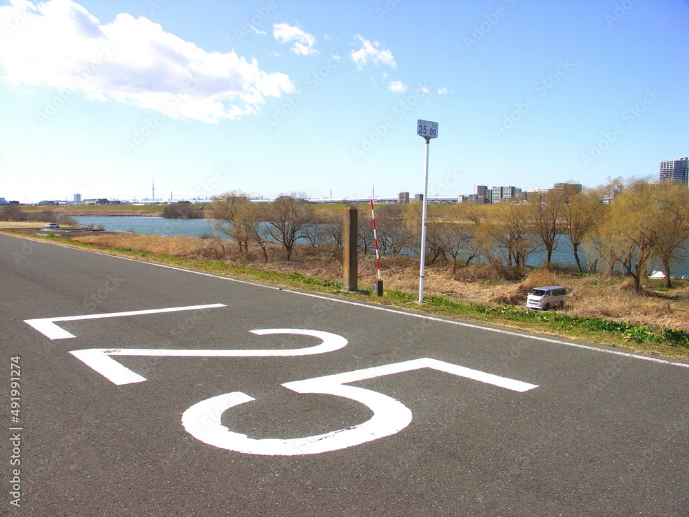 Obraz premium 海から25キロメートルのサイクリング道路のある春の江戸川左岸土手風景