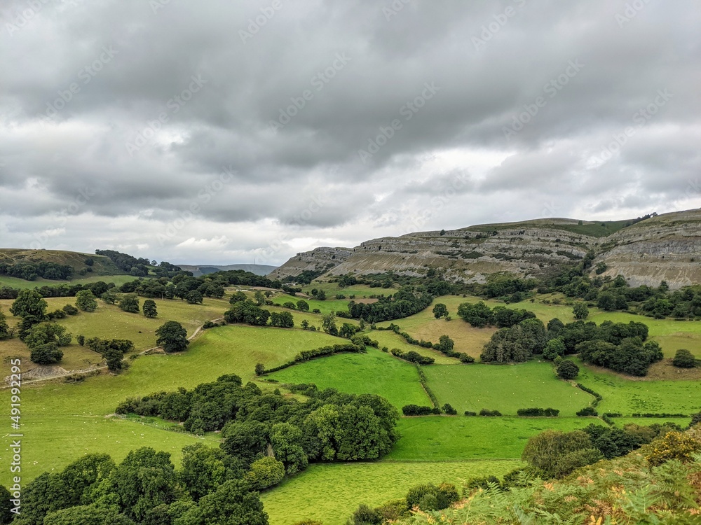 Limestone escarpment with green farm fields