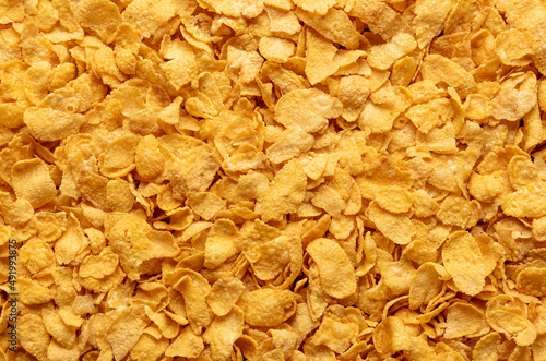 Cornflakes background, top view. Corn cereals texture.