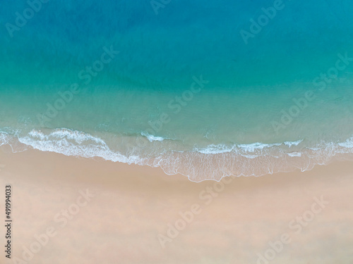 Aerial view Perspective of Waves and Beach from top view. Blue water background by drone.