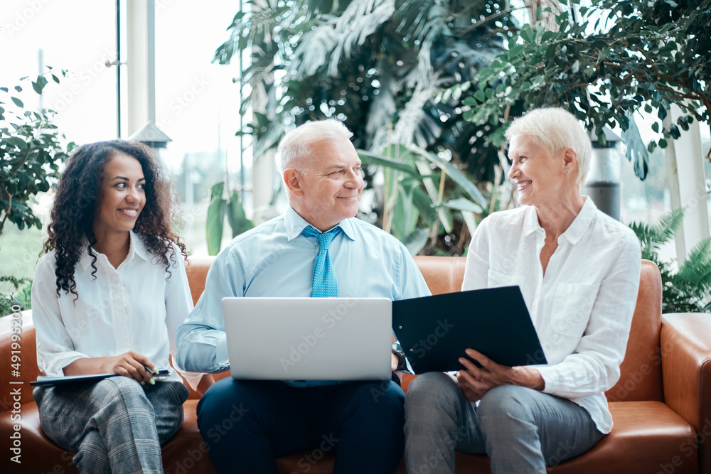 Fototapeta premium group of business people using a laptop sitting in the office lobby.