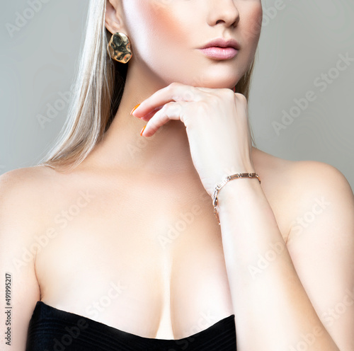 Billede på lærred Partial portrait of beautiful model woman with breast cleavage dress