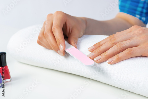 Woman using nail file and create nails shape