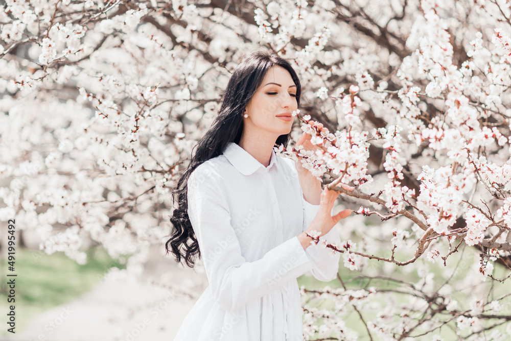 portrait of a woman in white blooming trees portrait of a woman in white blooming trees