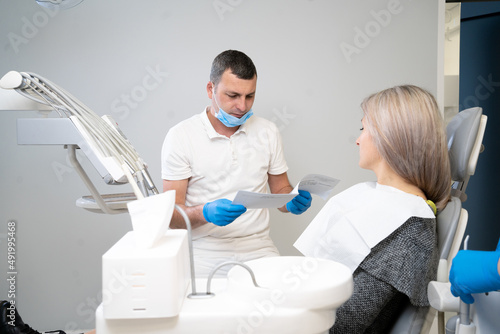 small conversation between a patient and a dentist, preparing for a dental checkup in a dental office. Regular visits to the orthodontist.