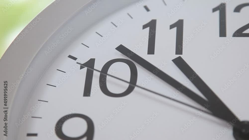 running wall clock with arrows
