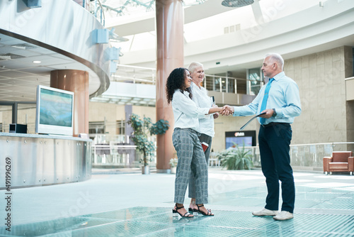 business center visitors meeting each other with a handshake .