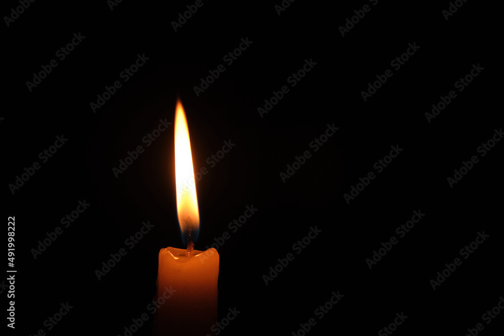 Flame burning candle black background.Concept memory and sorrow. Flame burning candle black background.Concept memory and sorrow.