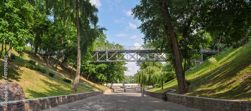Descent to the Sozh River and a pedestrian bridge on the territory of the palace and park ensemble of the city of Gomel in the Republic of Belarus