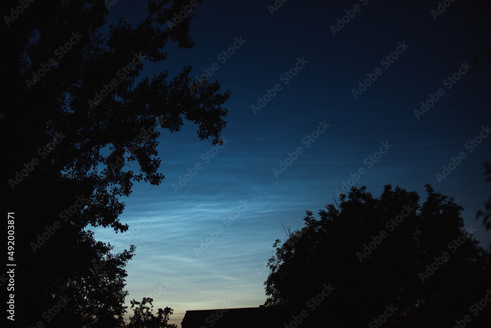 Noctilucent clouds on a summer evening in a Ukrainian village