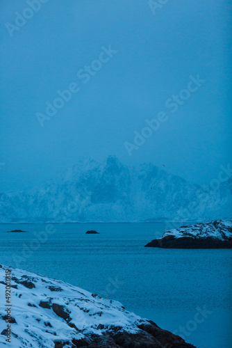 Small black island on deep blue sea - ocean and sky - Lofoten, Norway