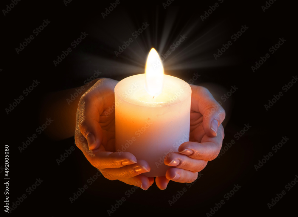 Women's hands holding a candle Women's hands holding a candle