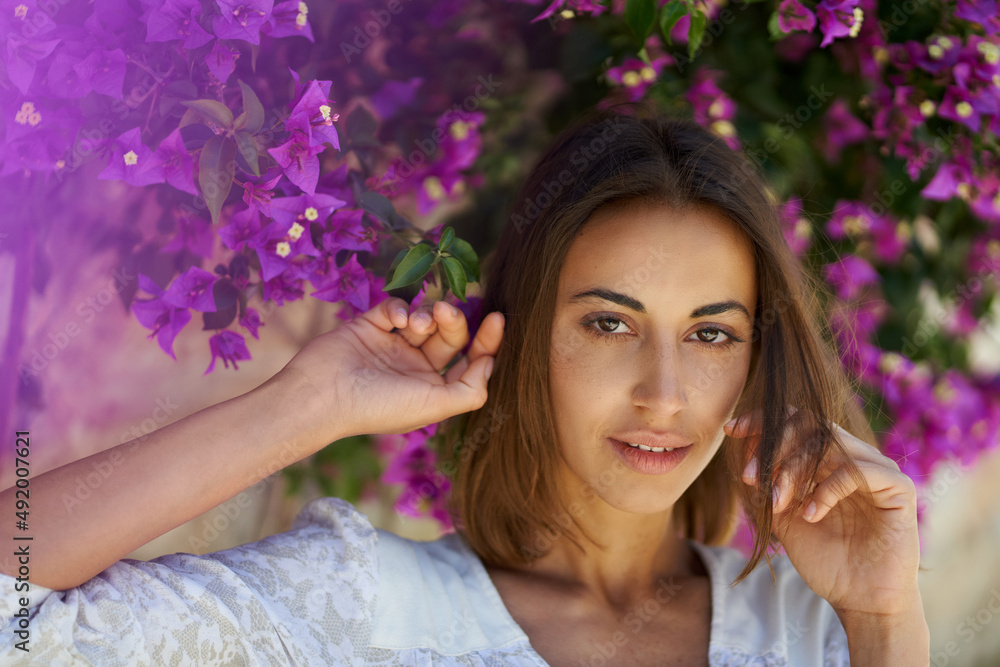 Beauty portrait close up face young attractive woman in spring garden with pink flowers Beauty portrait close up face young attractive woman in spring garden with pink flowers