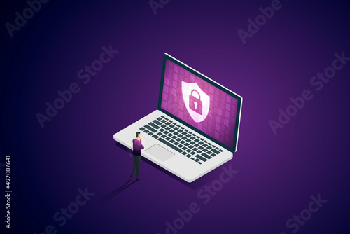 Fototapeta Naklejka Na Ścianę i Meble -  Businessman looking at security icon on laptop screen protecting personal.