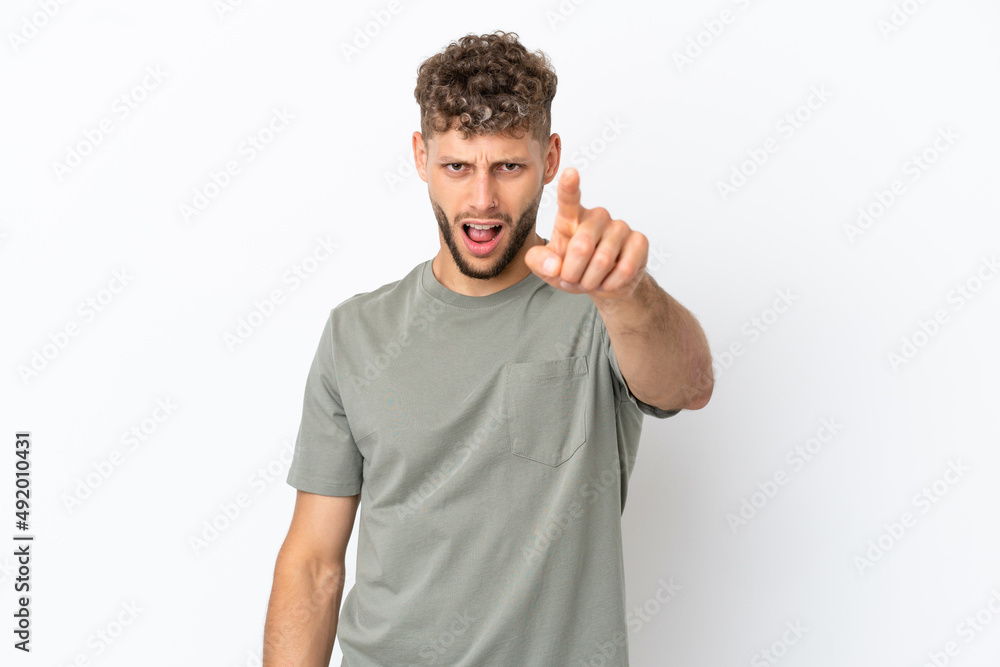 Young caucasian handsome man isolated on white background frustrated and pointing to the front Young caucasian handsome man isolated on white background frustrated and pointing to the front