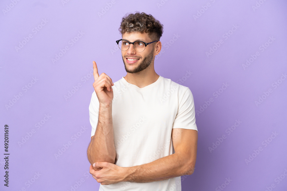 Delivery caucasian man isolated on purple background pointing up a great idea Delivery caucasian man isolated on purple background pointing up a great idea