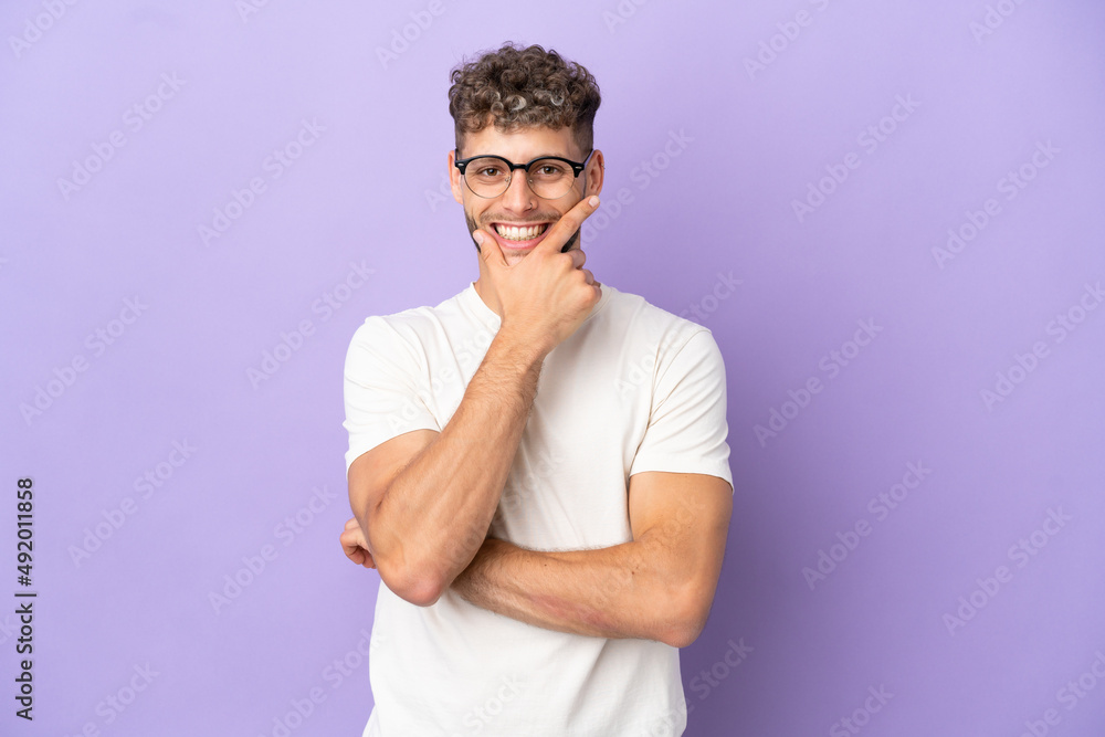 Delivery caucasian man isolated on purple background happy and smiling Delivery caucasian man isolated on purple background happy and smiling