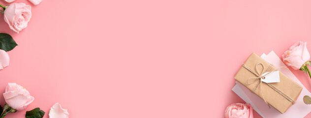 Mother's Day design concept background with pink rose flower and gift on pink background.
