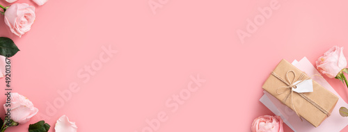 Mother's Day design concept background with pink rose flower and gift on pink background.