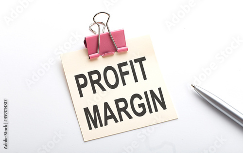 PROFIT MARGIN text on sticker with pen on the white background