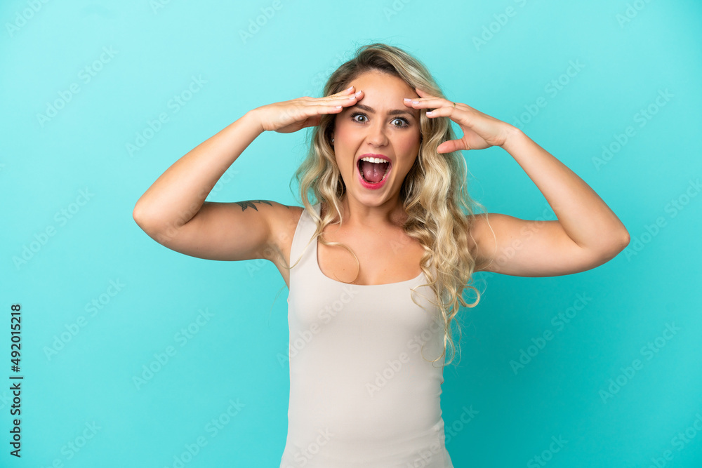 Young Brazilian woman isolated on blue background with surprise expression Young Brazilian woman isolated on blue background with surprise expression