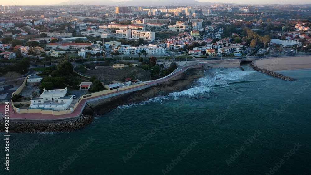 Obraz premium santo amaro in a huge sunset over ocean seeing the city