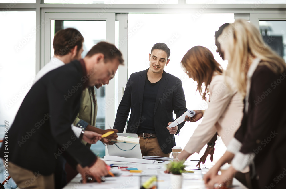 Concluding another informative meeting. Shot of a group of businesspeople having a meeting in a boardroom. Concluding another informative meeting. Shot of a group of businesspeople having a meeting in a boardroom.