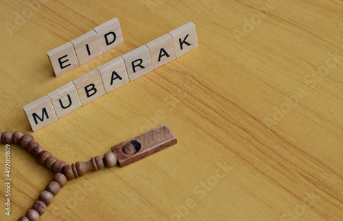 eid mubarak text on wooden square, islamic quotes