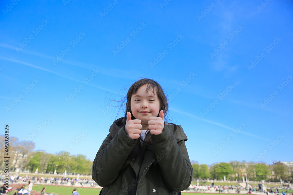 Fototapeta premium Portrait of little girl smiling in Luxembourg Gardens, Paris